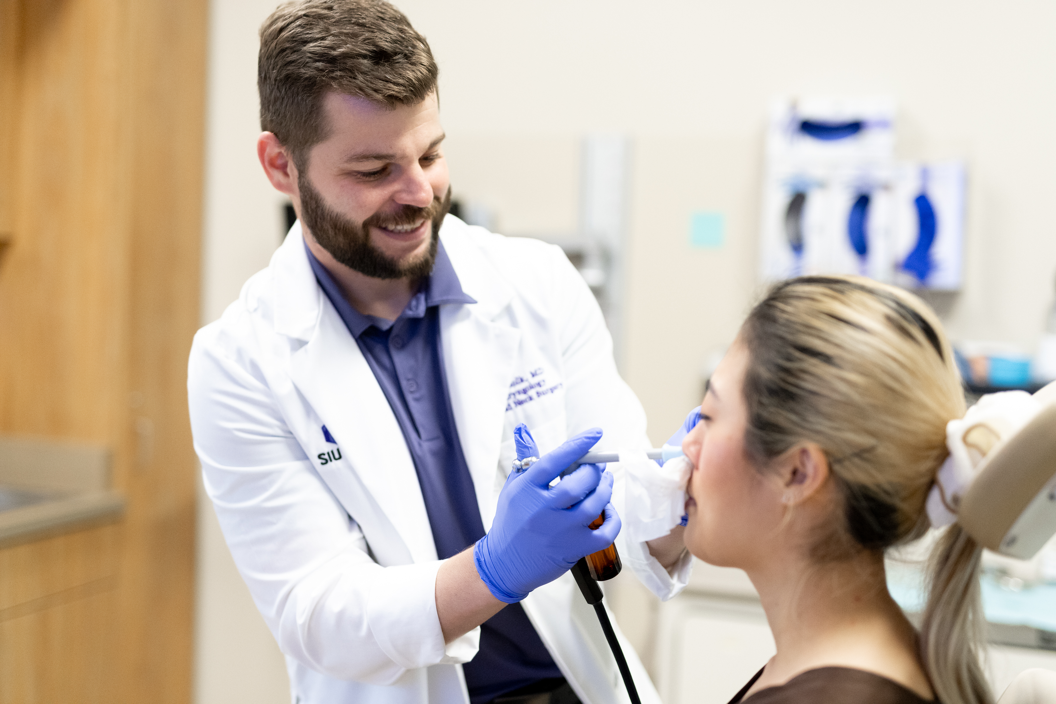 Dr. Bolk working examining patient's nose