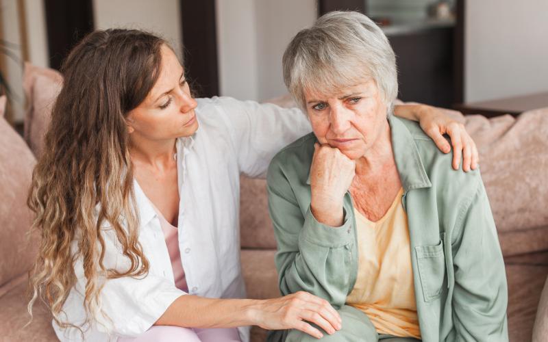 Young woman consoling agitated older woman