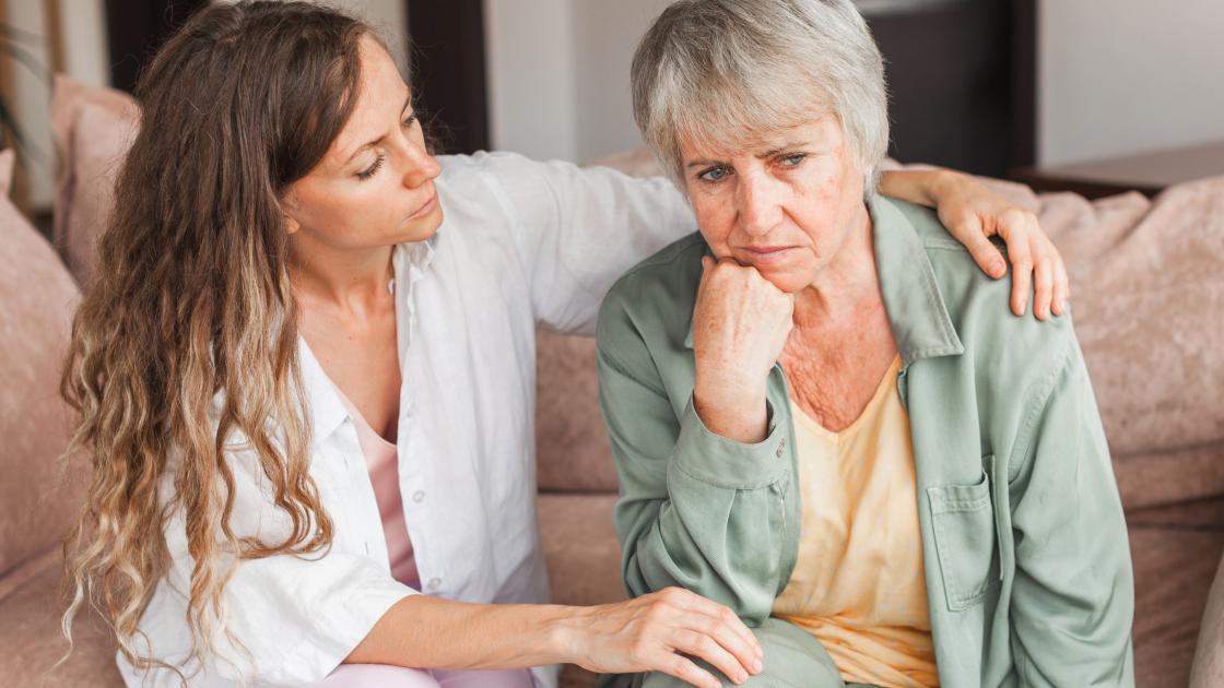 Young woman consoling agitated older woman