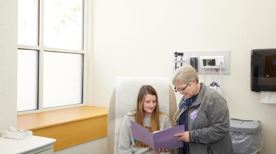 nurse and patient look at folder